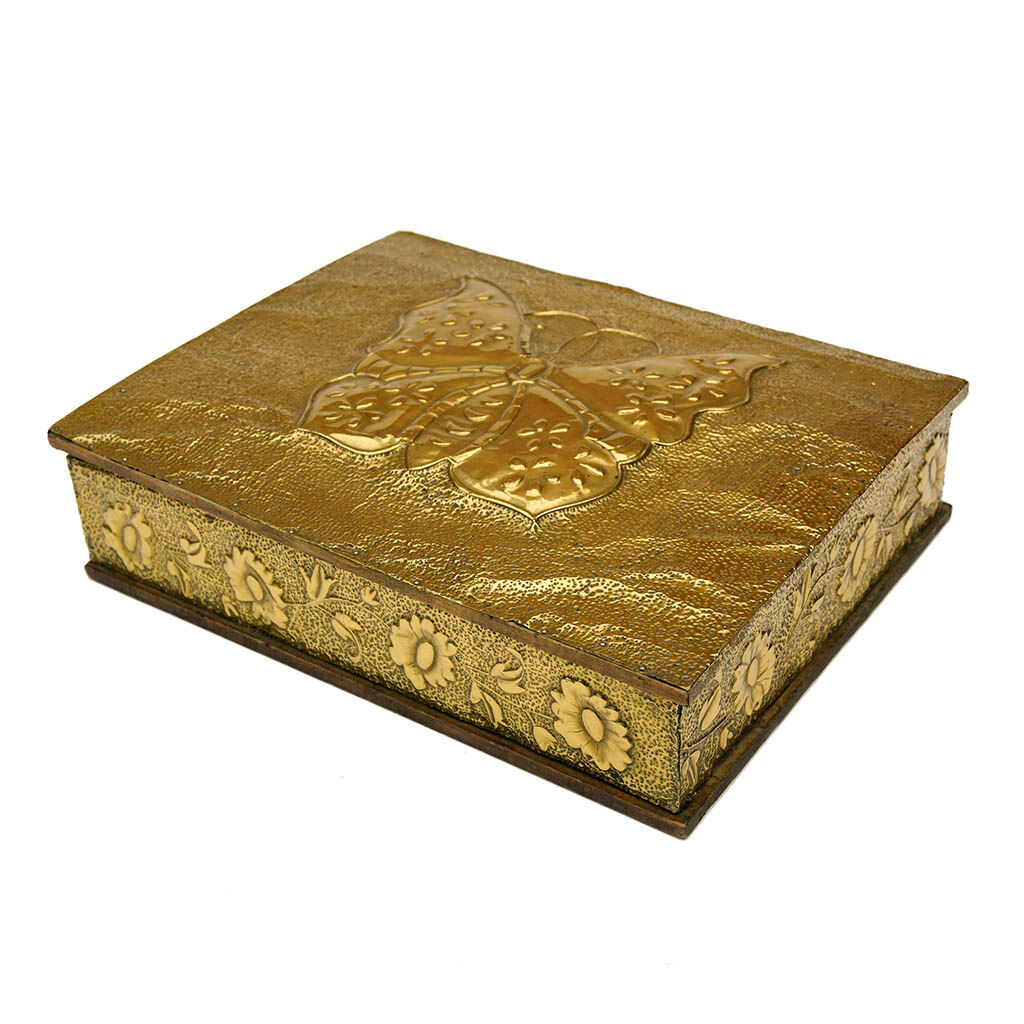 Old wooden box decorated with carved gold metal repelled vintage butterfly
