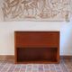 Vintage teak bar cabinet with black glass interior.
