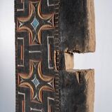 Indonesian construction element in carved wood with cross pattern in red, white geometric frieze