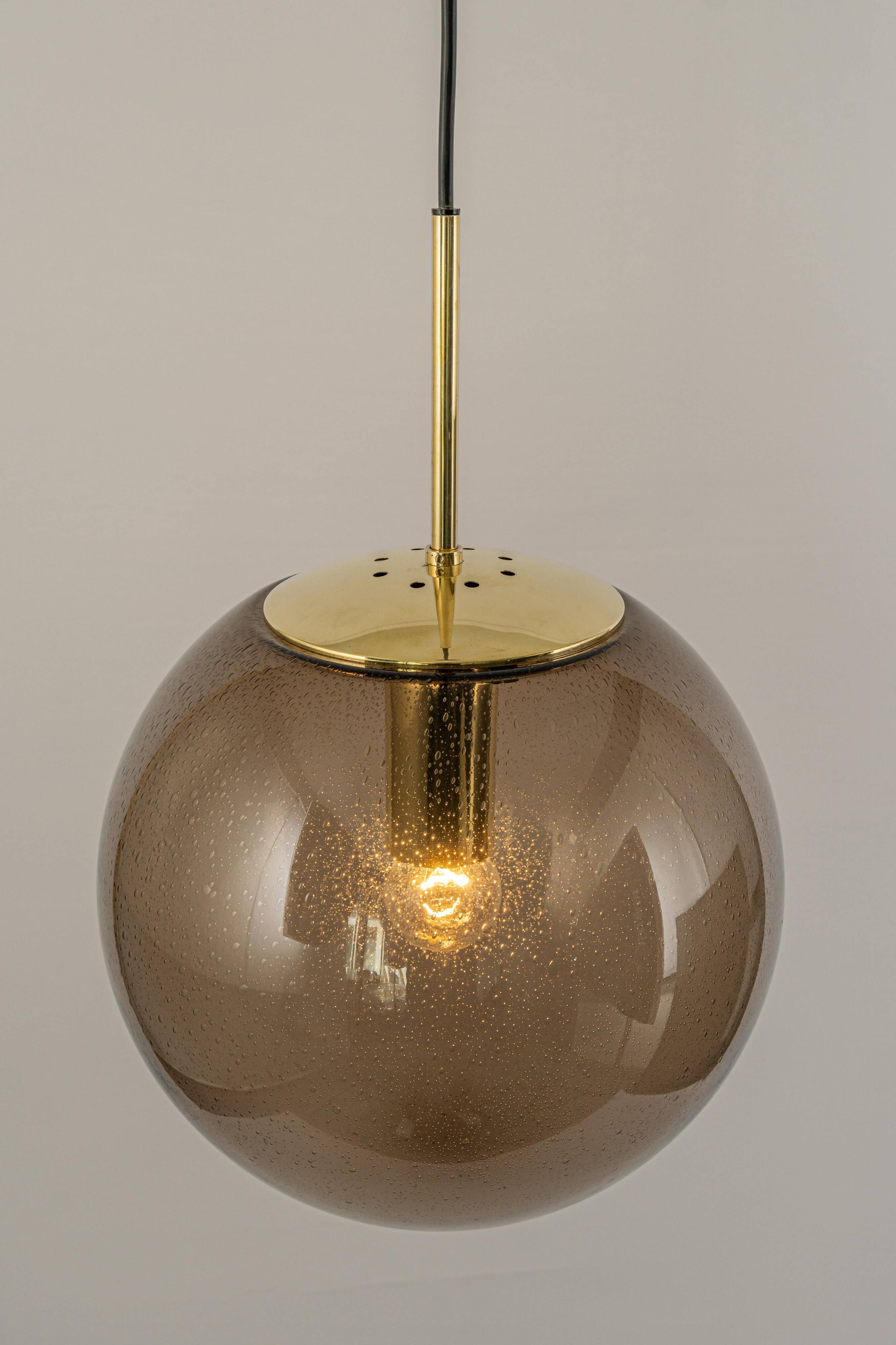 Large smoked glass ball pendant by Limburg in brass, Germany, 1970s.