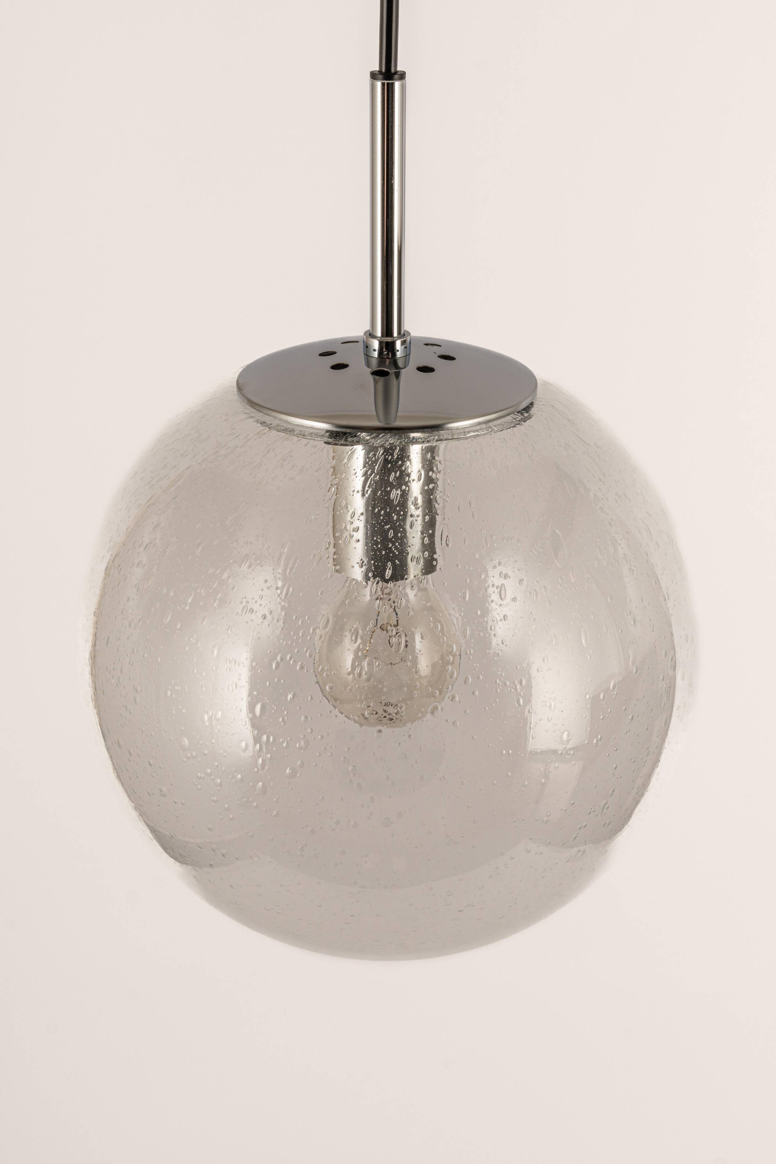 Small Limburg chrome pendant light with clear glass globe, Germany, 1970s.