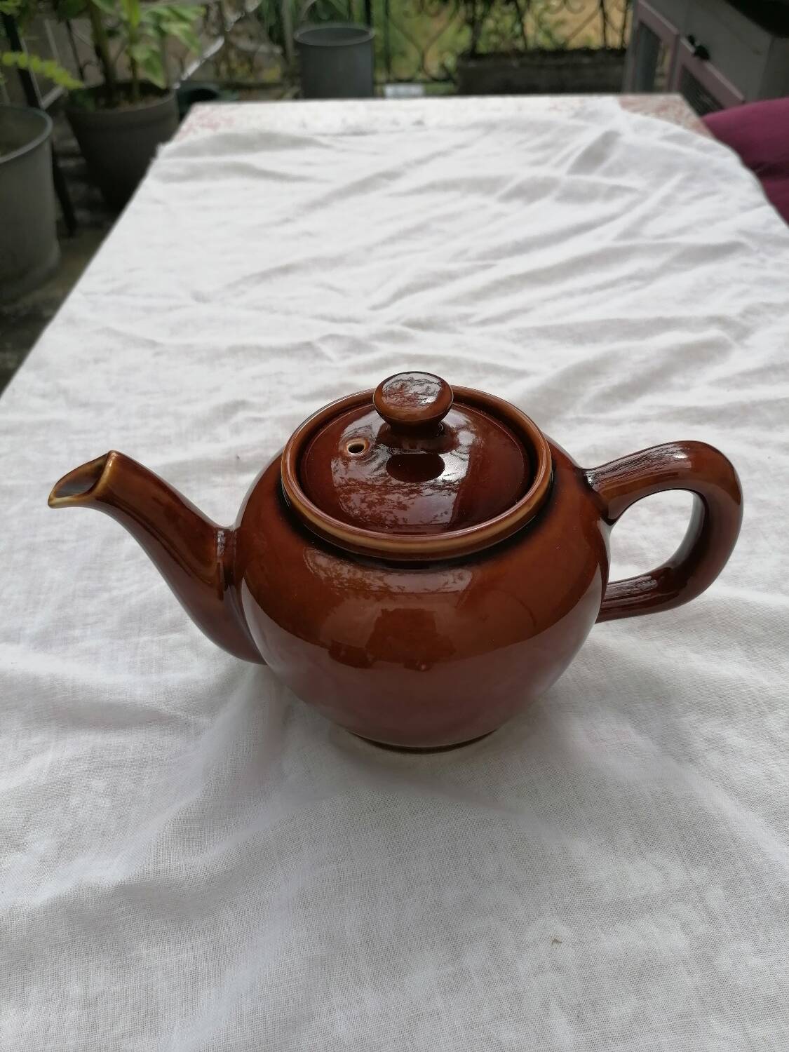 Brown ceramic teapot and milk jugs