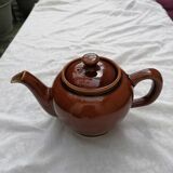 Brown ceramic teapot and milk jugs