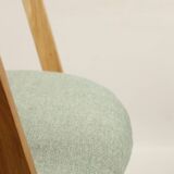 Vintage dining chair in light oak with natural linen pastel green fabric.