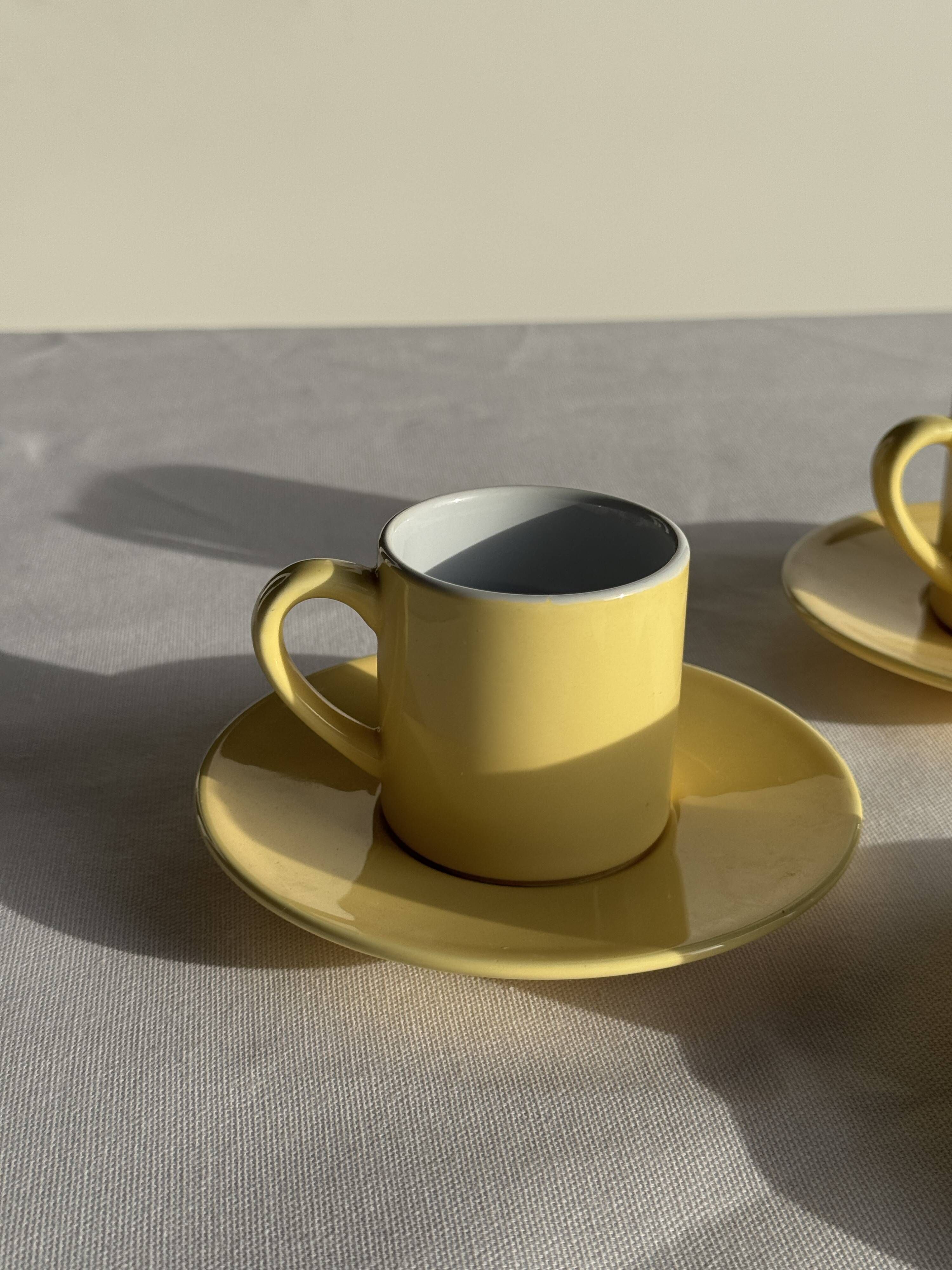 Set of 4 vintage yellow Italian espresso cups and saucers.
