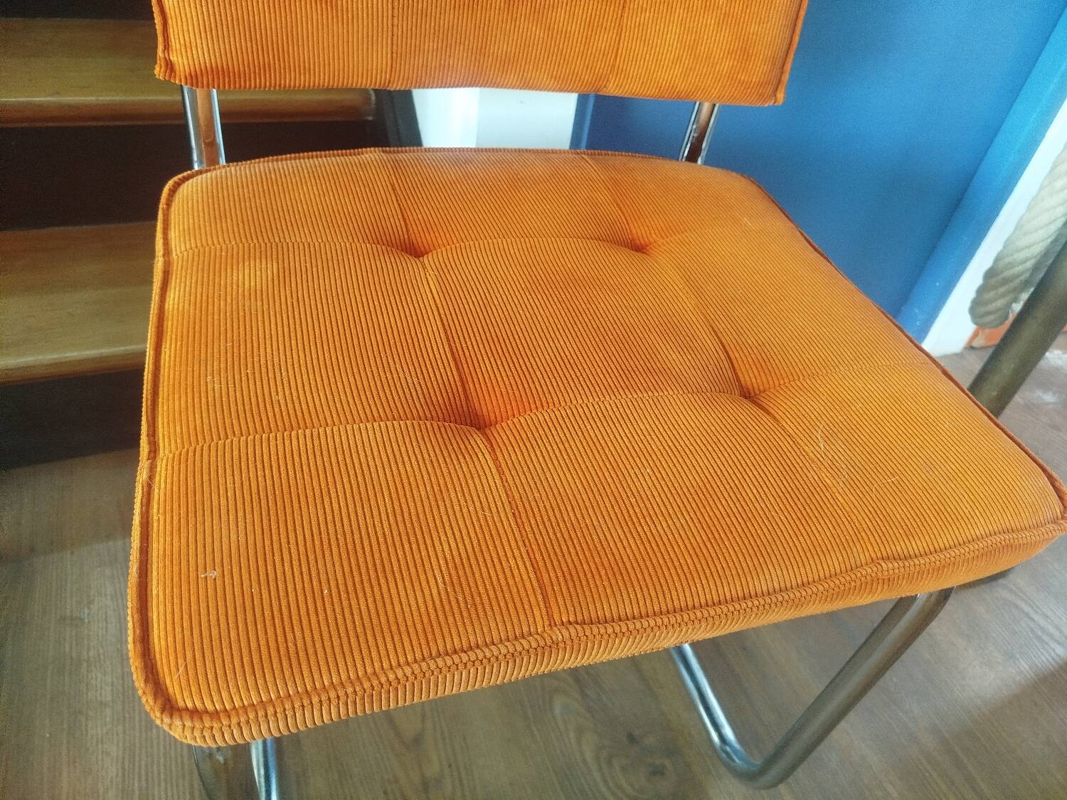 Pair of vintage cantilever chairs in chrome and orange corduroy.
