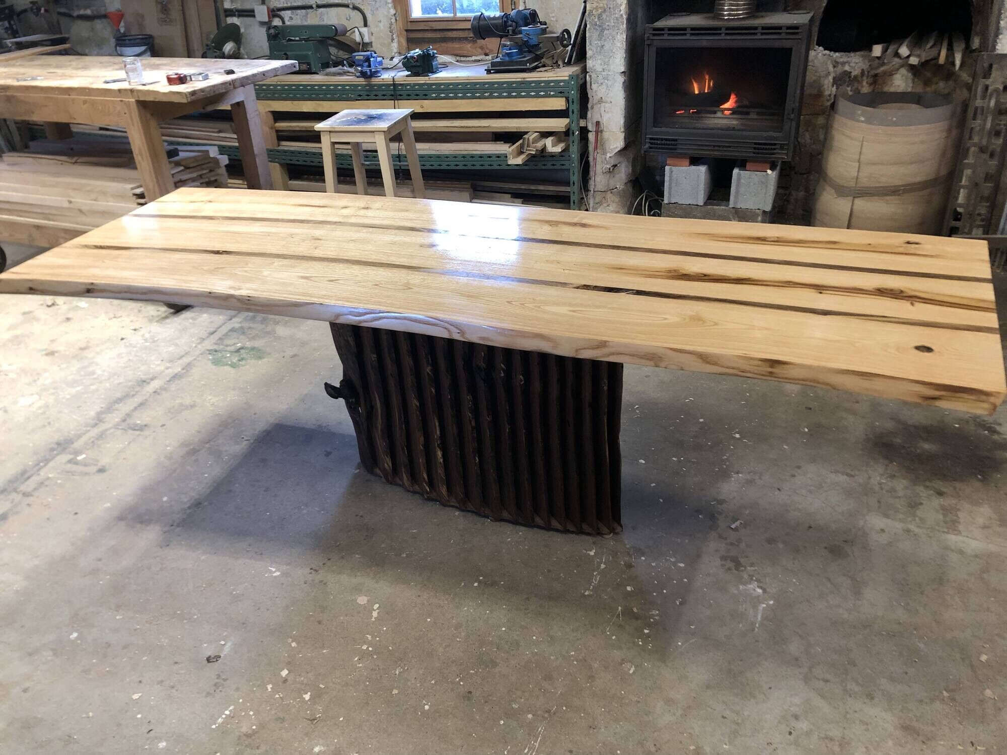 Chestnut and walnut solid table and benches with a central leg.