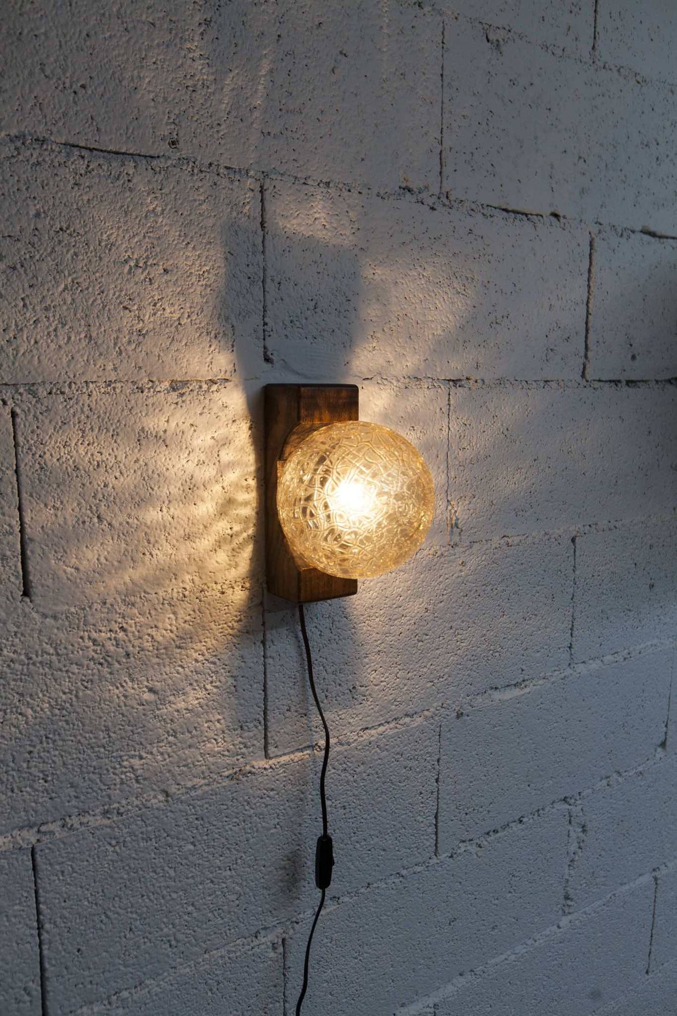 1960s ball wall light in dark wood and amber glass