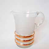 set composed of a pitcher and two large white granite glasses with gold edging from the 60s