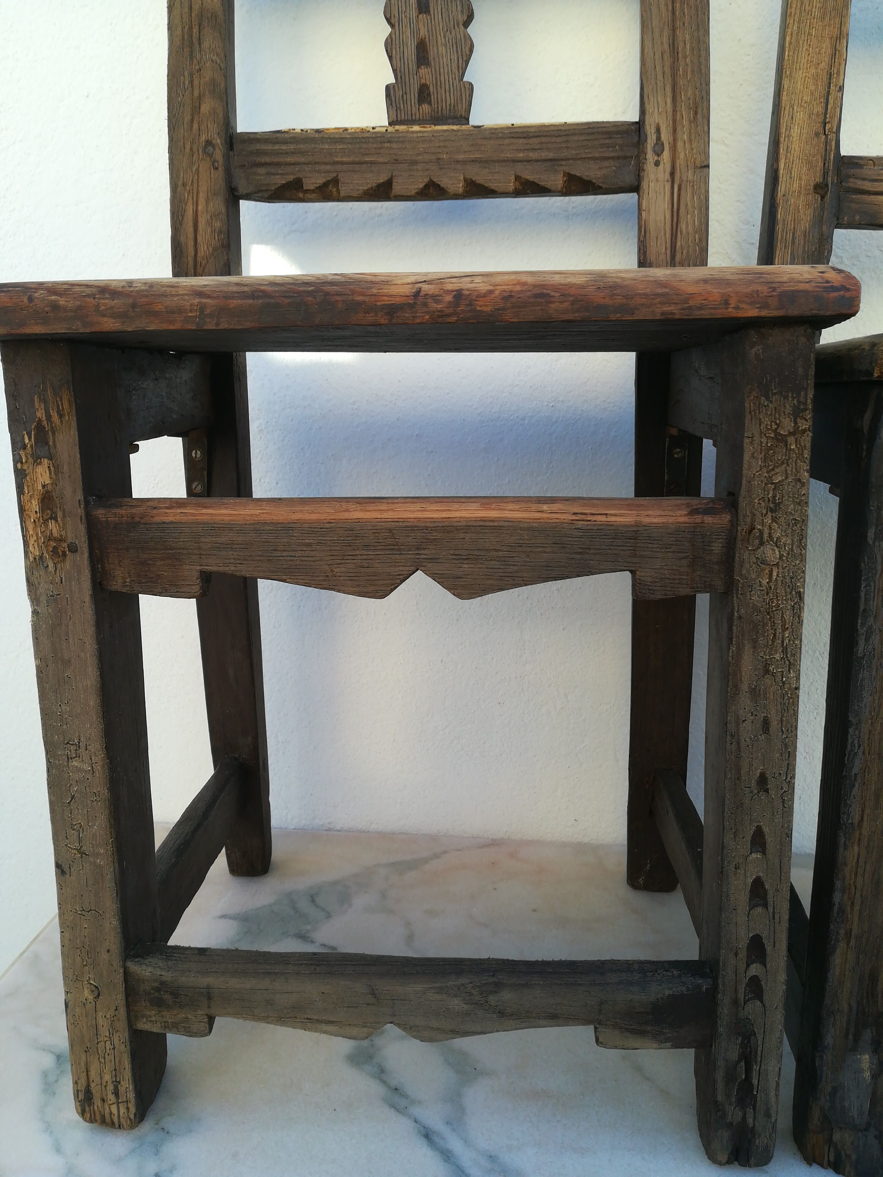 Pair of ethnic crude wooden chairs