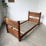 Brutalist style bed with chain and straw