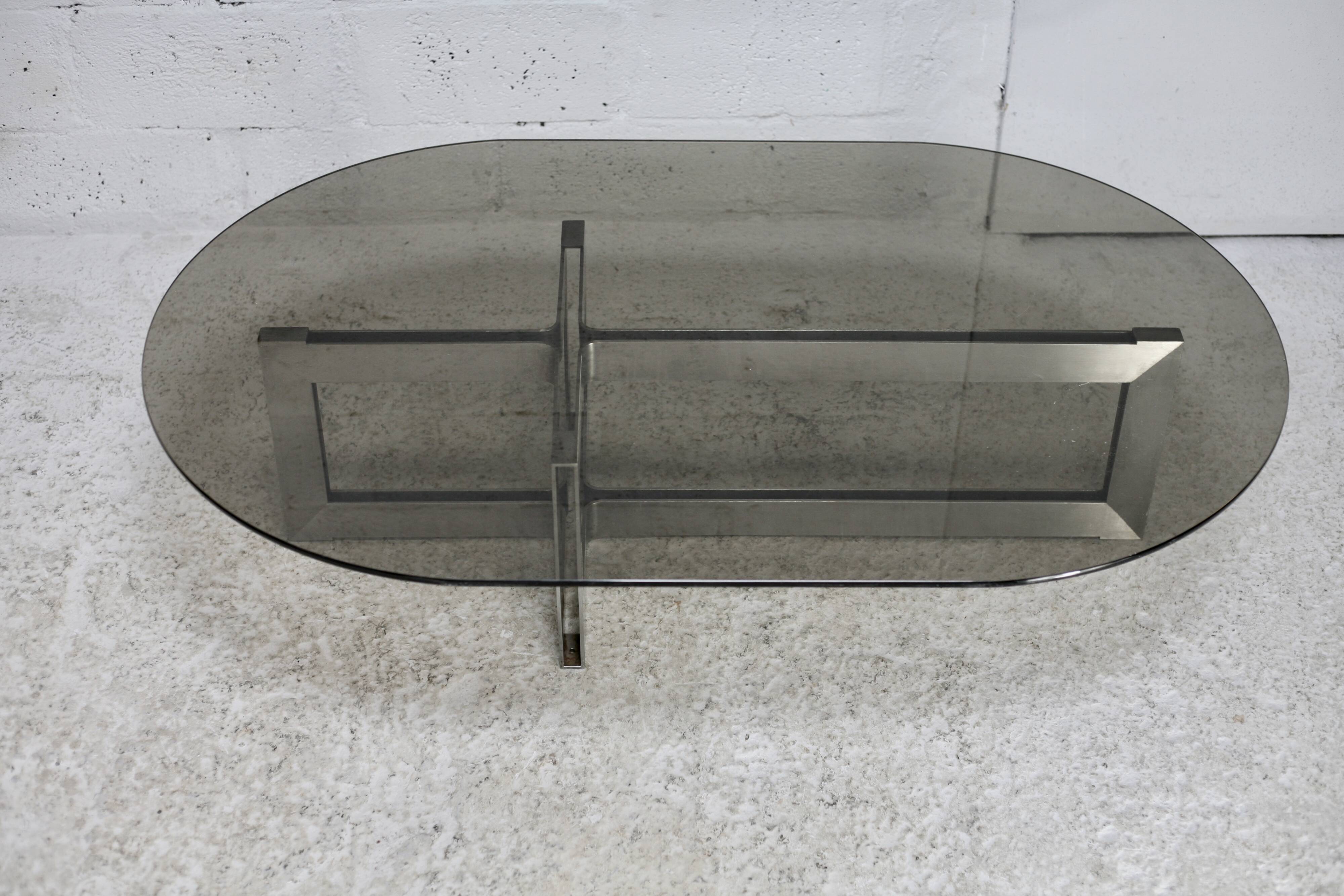 Coffee table with steel base and smoked glass slab. Circa 197