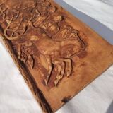 Bas-relief plaster scene of horses and a cart.