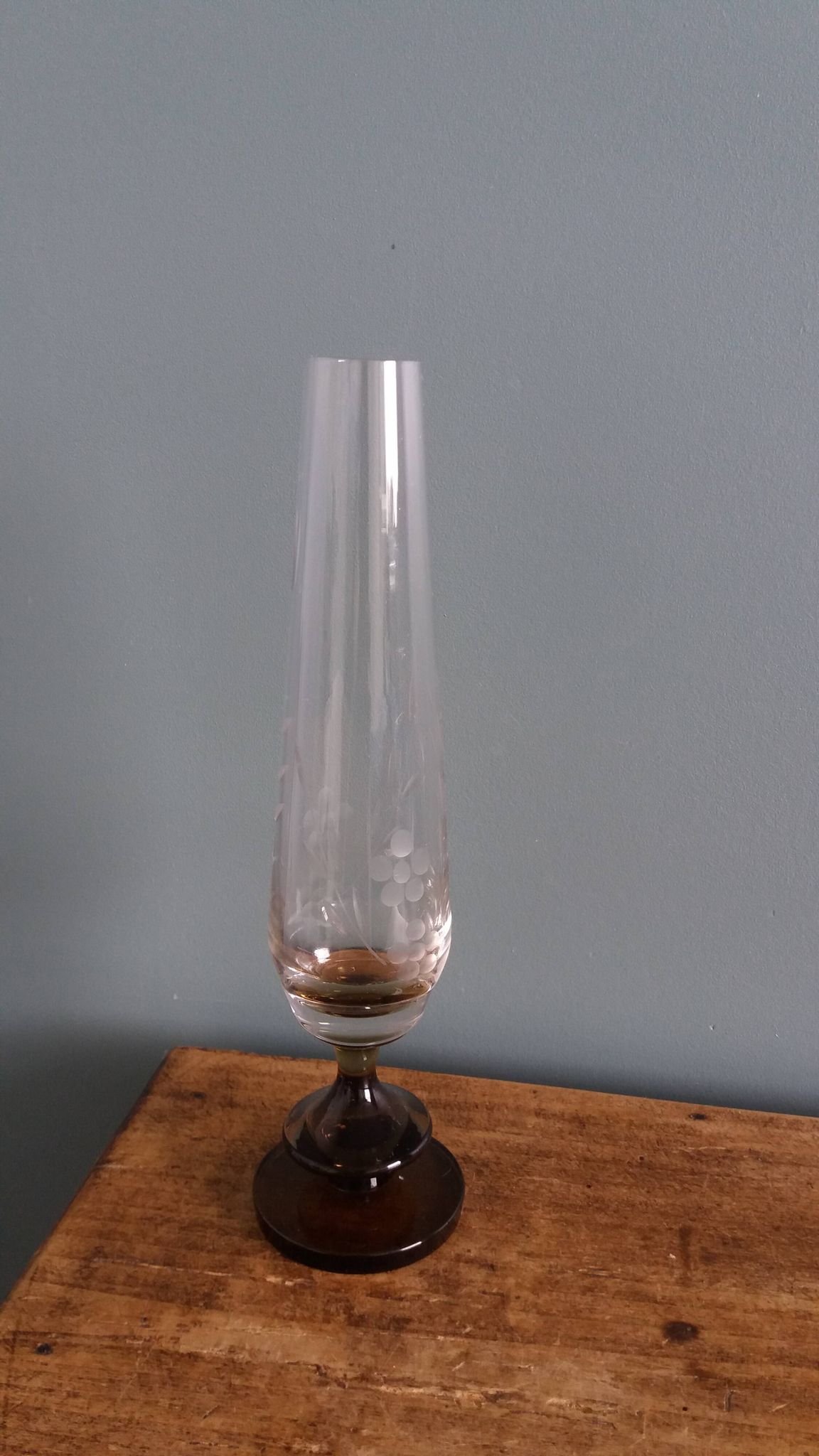 Cut glass soliflore vase with a smoked glass base.