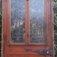 Oak entrance door and its frame and transom, wrought iron gates