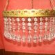 circular chandelier with a brass frame and crystal drops