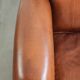 Sheepskin armchair with comfortable seat and finished with decorative nails