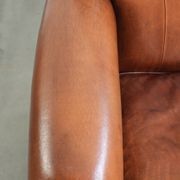Sheepskin armchair with comfortable seat and finished with decorative nails
