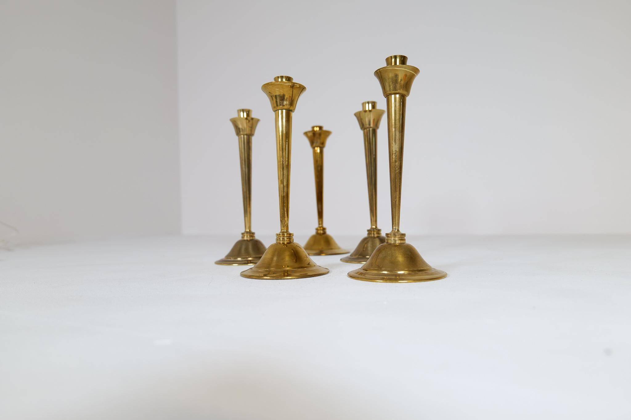 Mid-century set of 5 brass candlesticks by Lars Holmström, Arvika, Sweden.