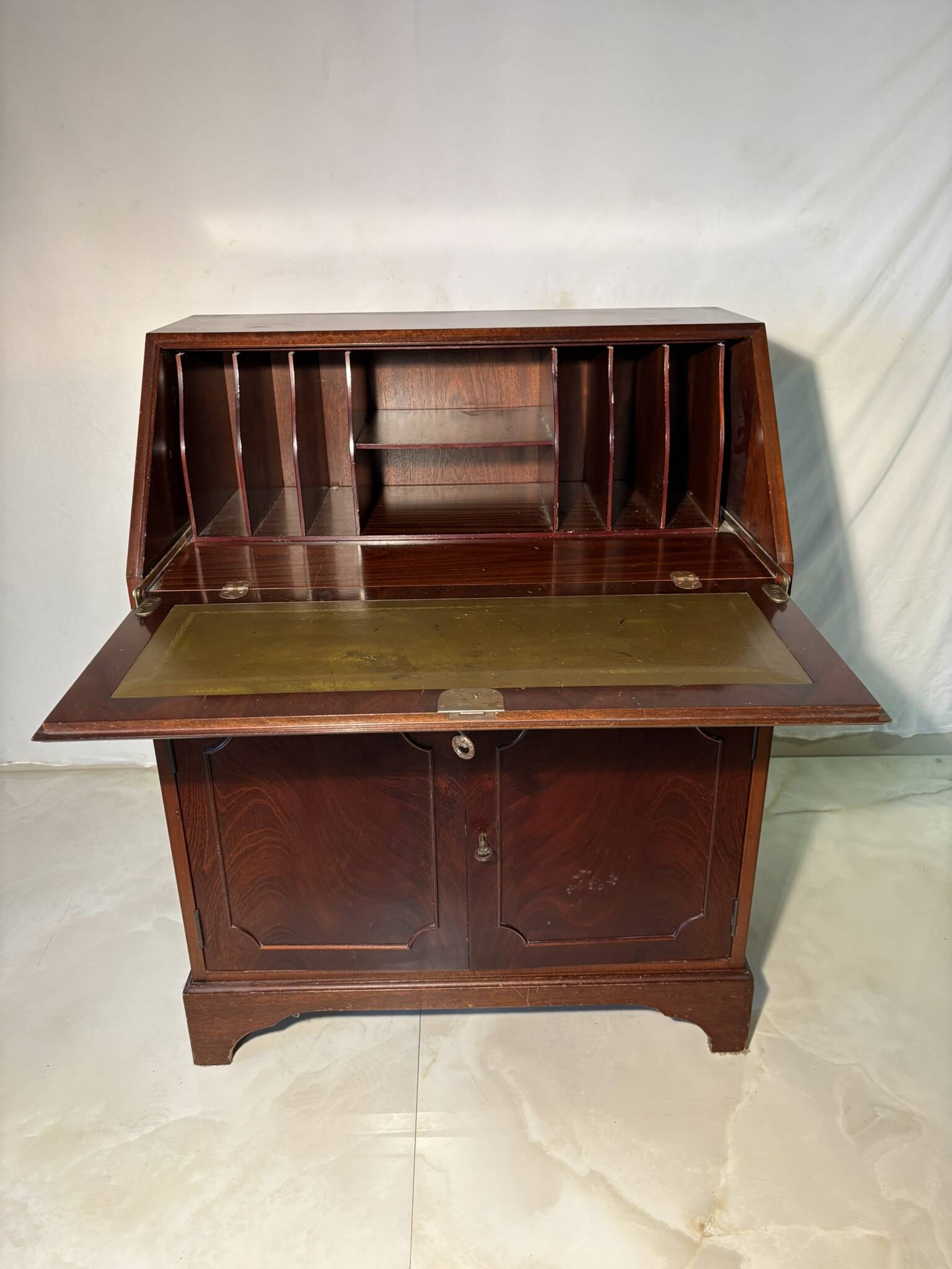 Antique mahogany secretary, upholstered flap and interior storage