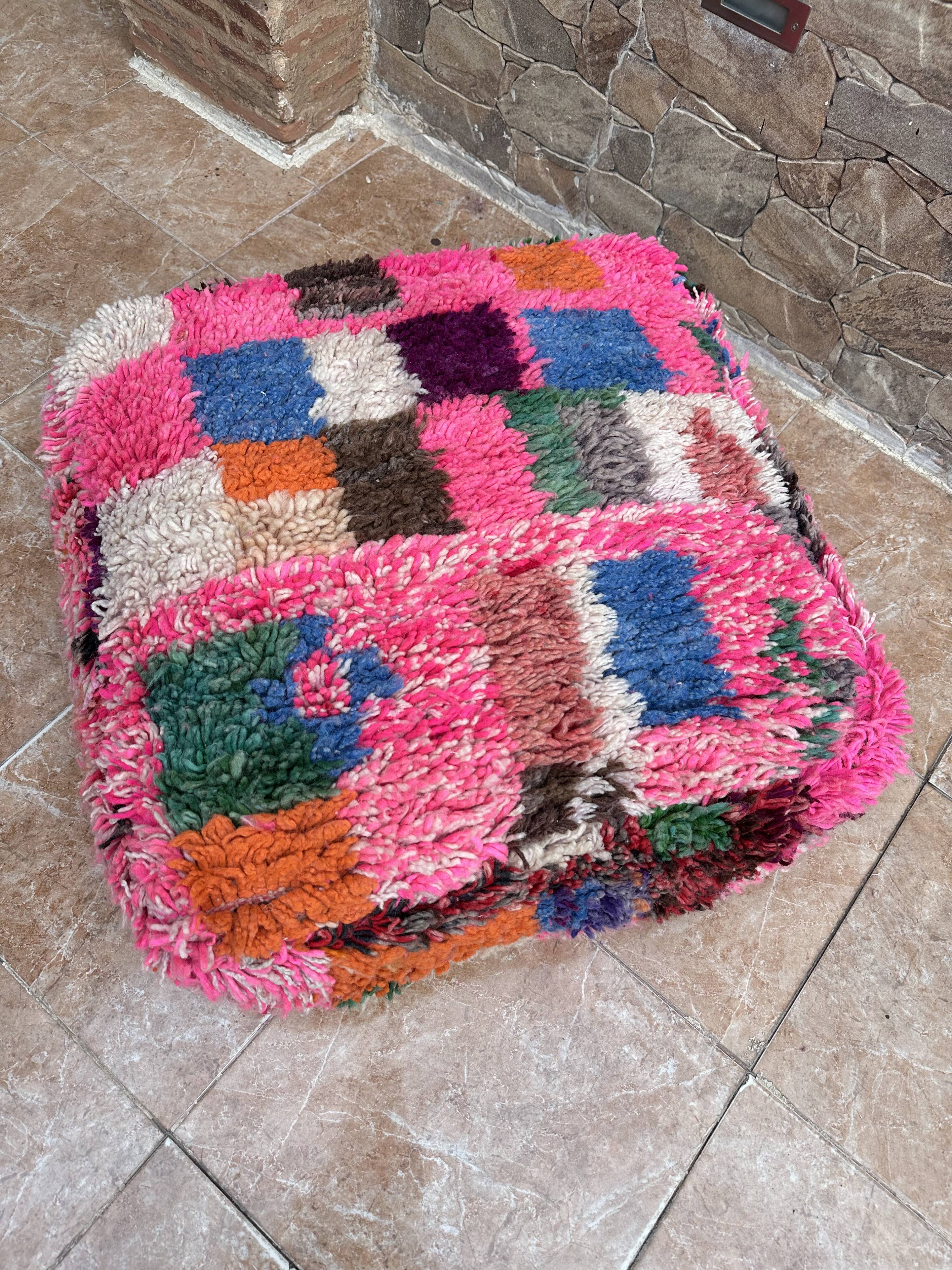 Berber floor pouf: Handwoven Moroccan wool cushion.