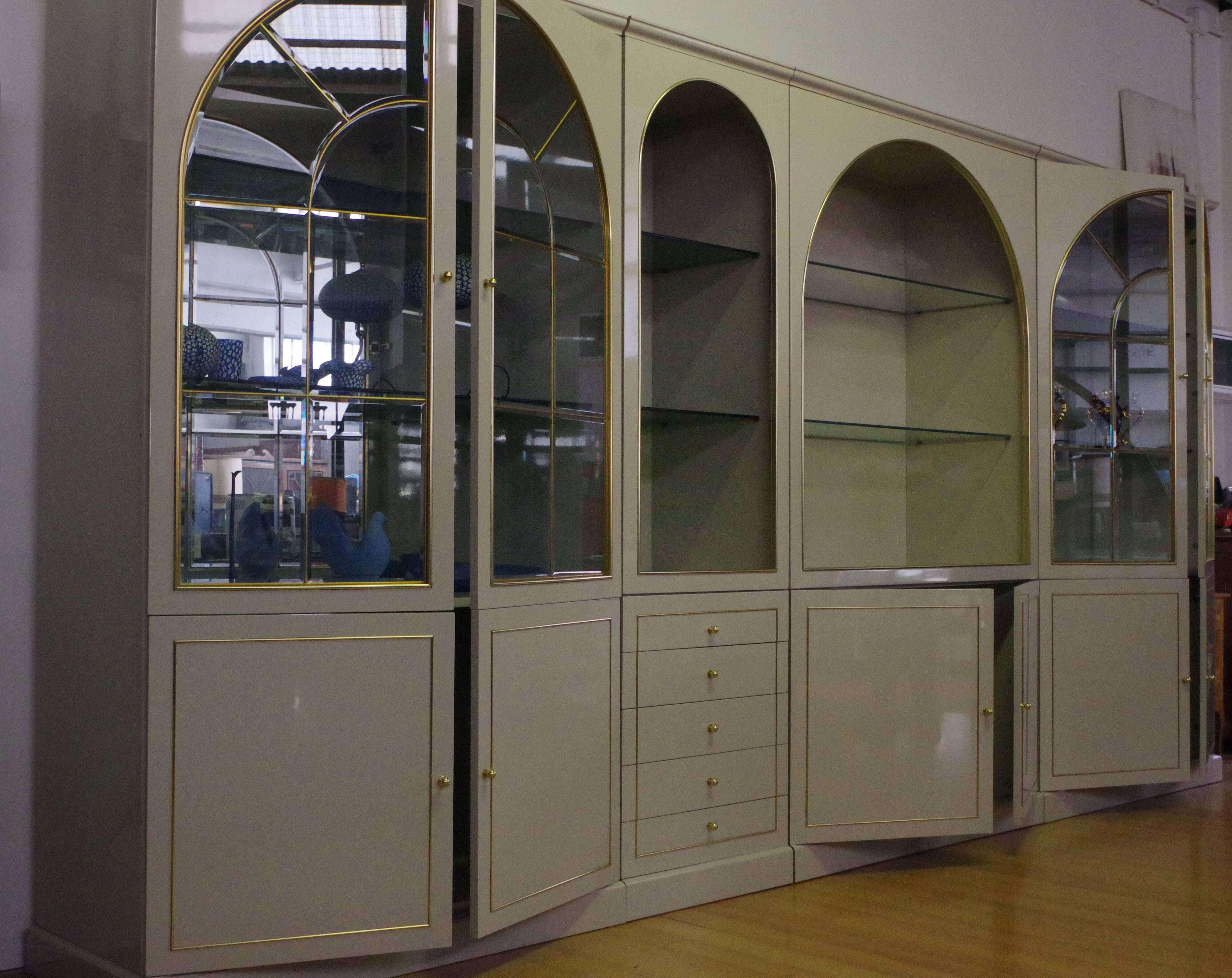 Showcases in lacquered wood, glass and brass  1970s, set of 4